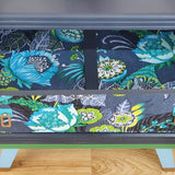 Grey mid-century chest of three drawers with découpaged fronts