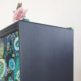 Grey mid-century chest of three drawers with découpaged fronts