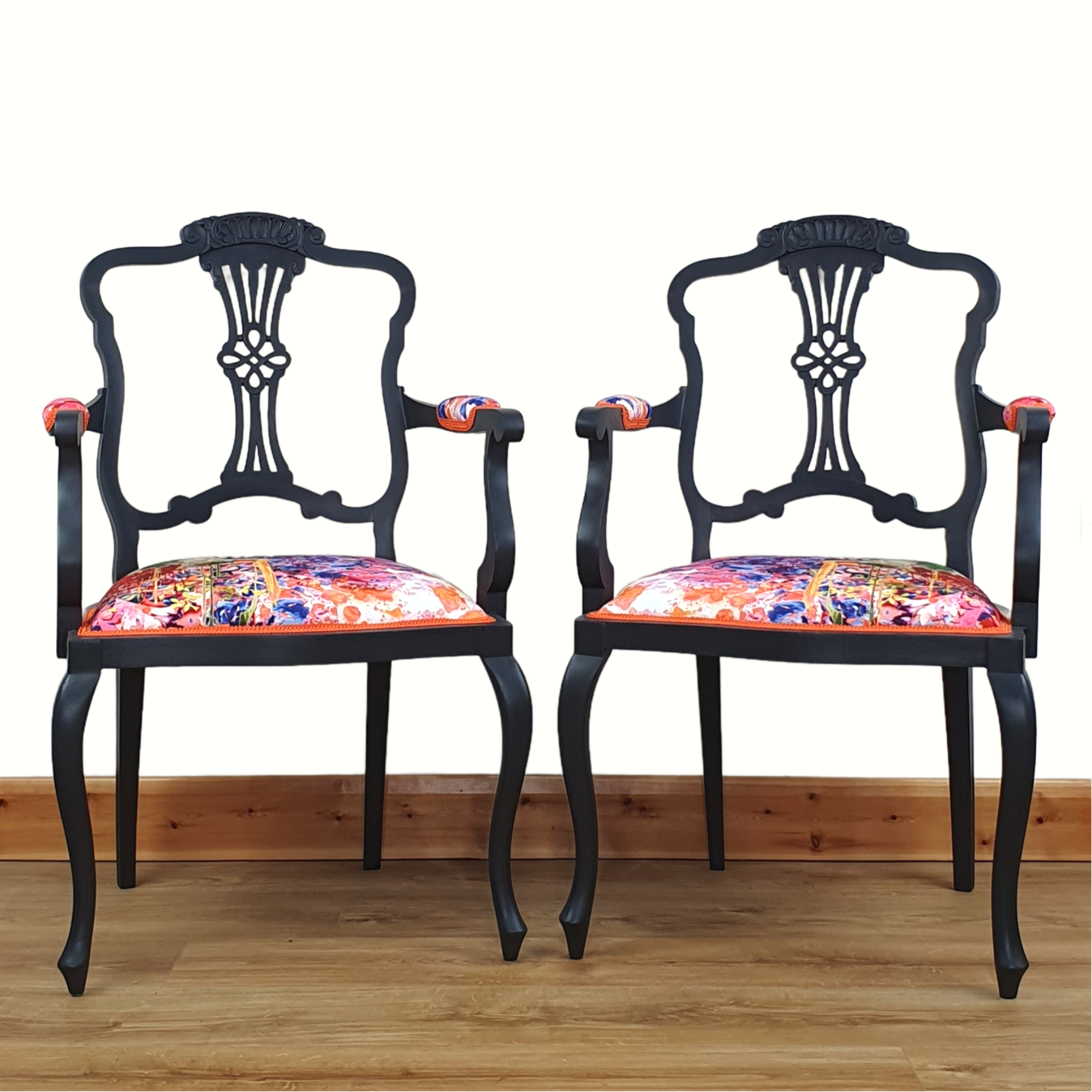 Pair of black-painted, upholstered armchairs