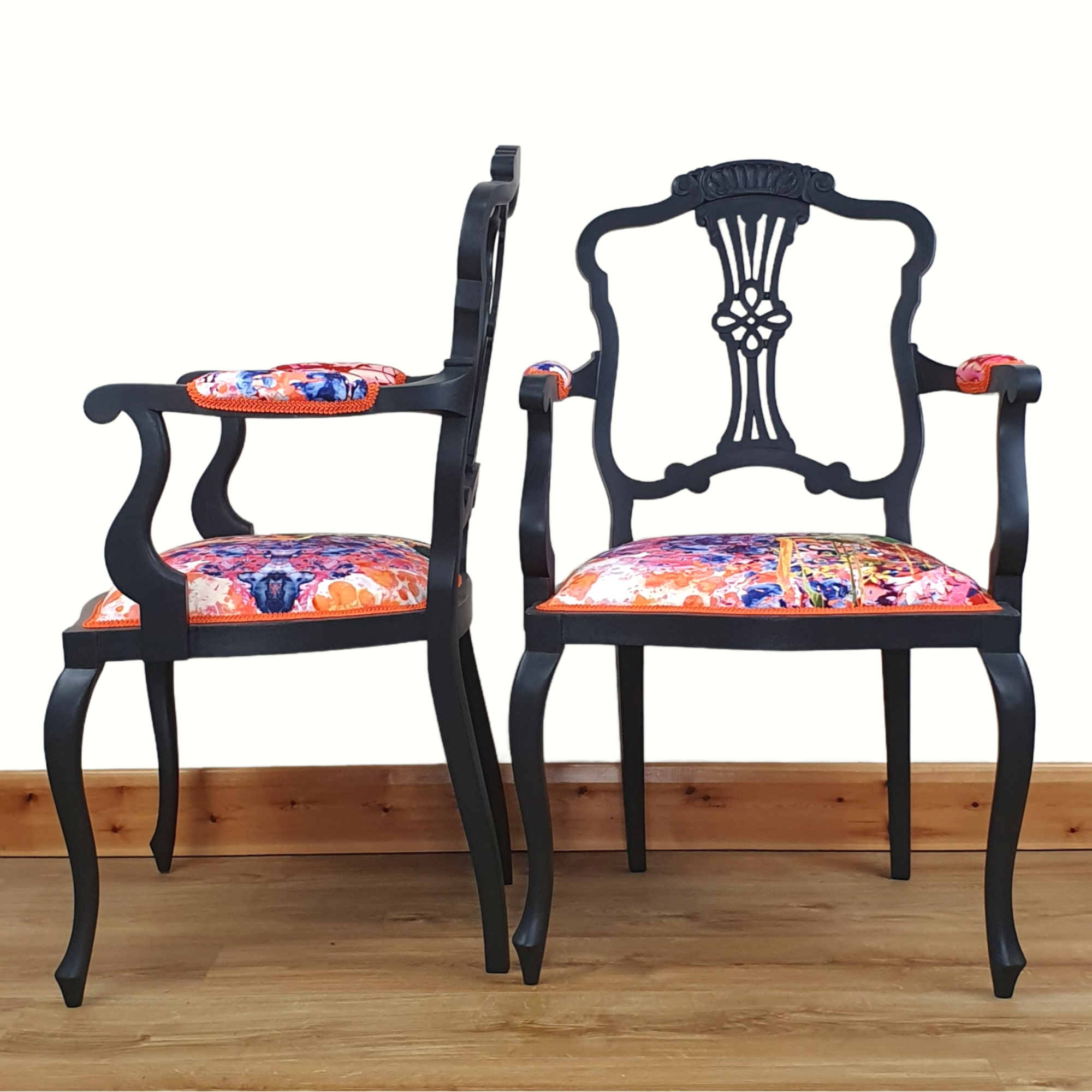 Pair of black-painted, upholstered armchairs