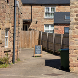 Getting closer to Godfrey's Ear, showing the way between the buildings, guided by the A-board