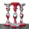 Hand-painted red wooden candlesticks with swirls of silver gilding