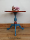 Blue tripod occasional table with floral decoration