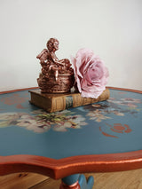 Blue tripod occasional table with floral decoration