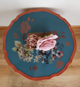 Blue tripod occasional table with floral decoration