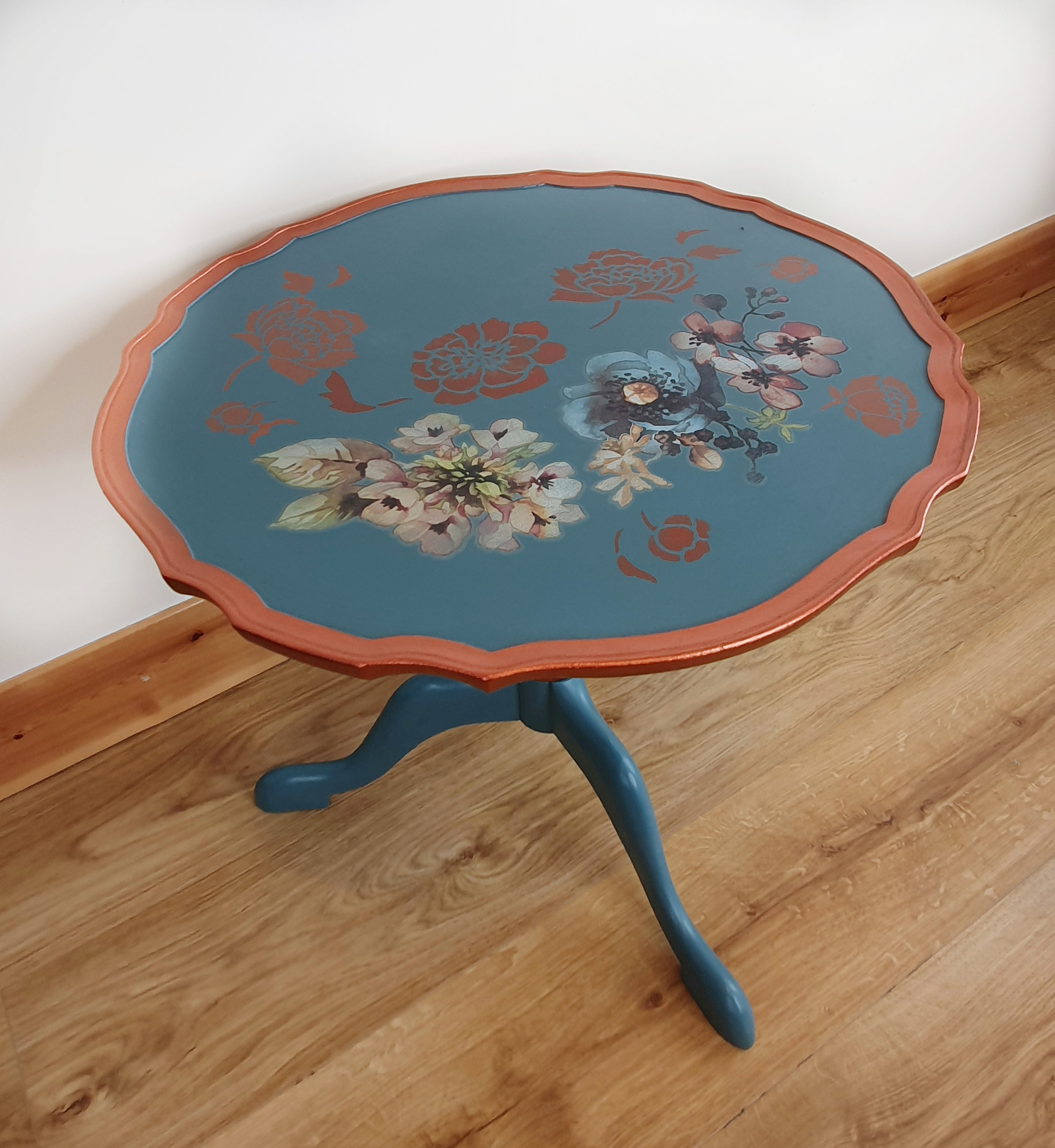 Blue tripod occasional table with floral decoration