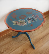 Blue tripod occasional table with floral decoration