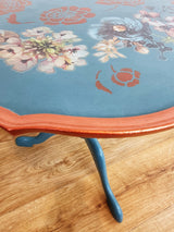 Blue tripod occasional table with floral decoration