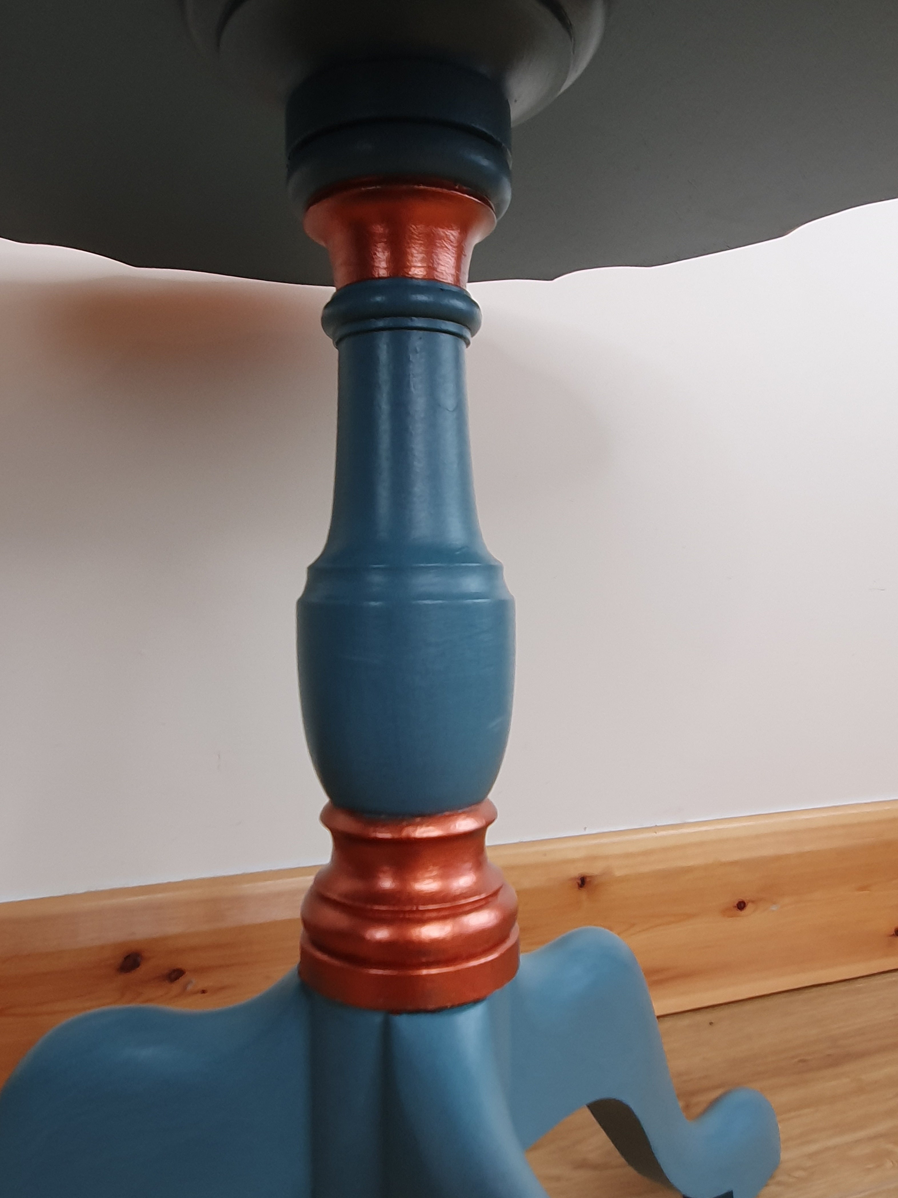 Blue tripod occasional table with floral decoration