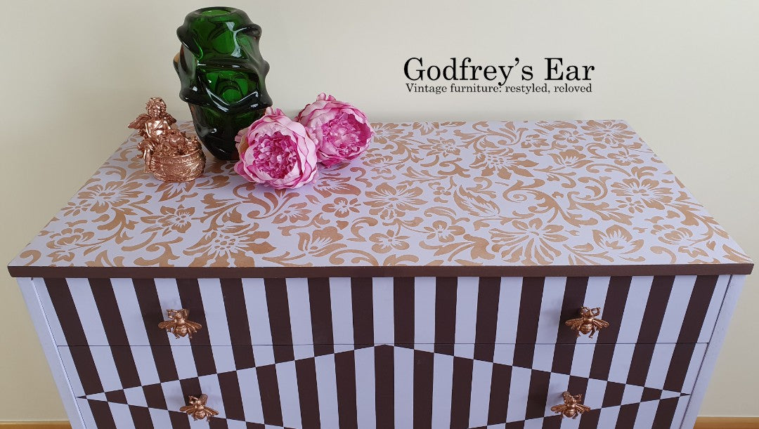 Pink Avalon chest of five drawers, with stripes and copper stencilling